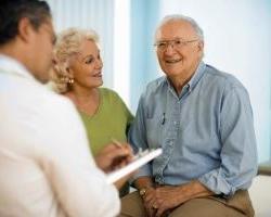 senior couple speaking to physician 